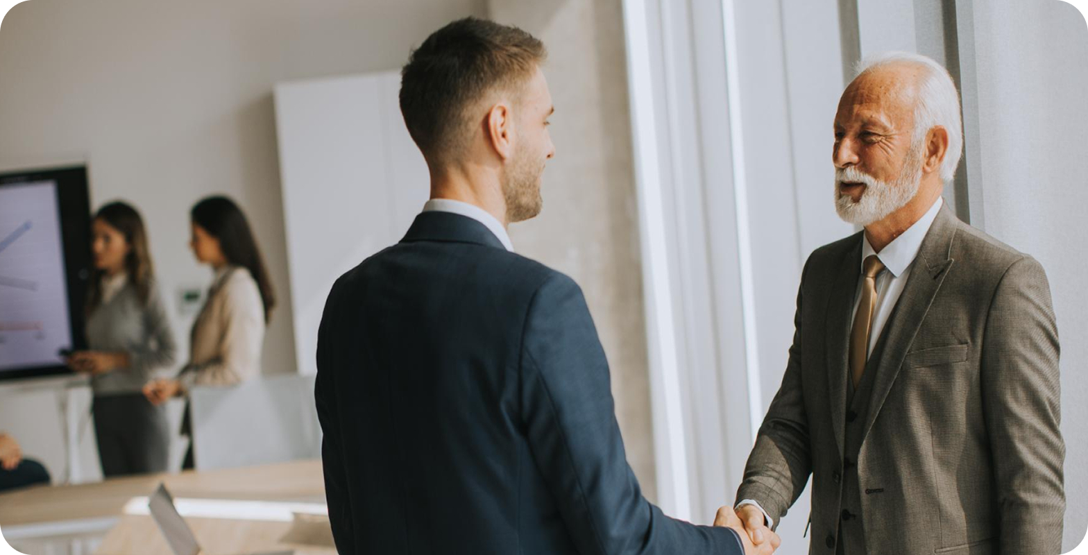 Two people shaking hands after a business meeting