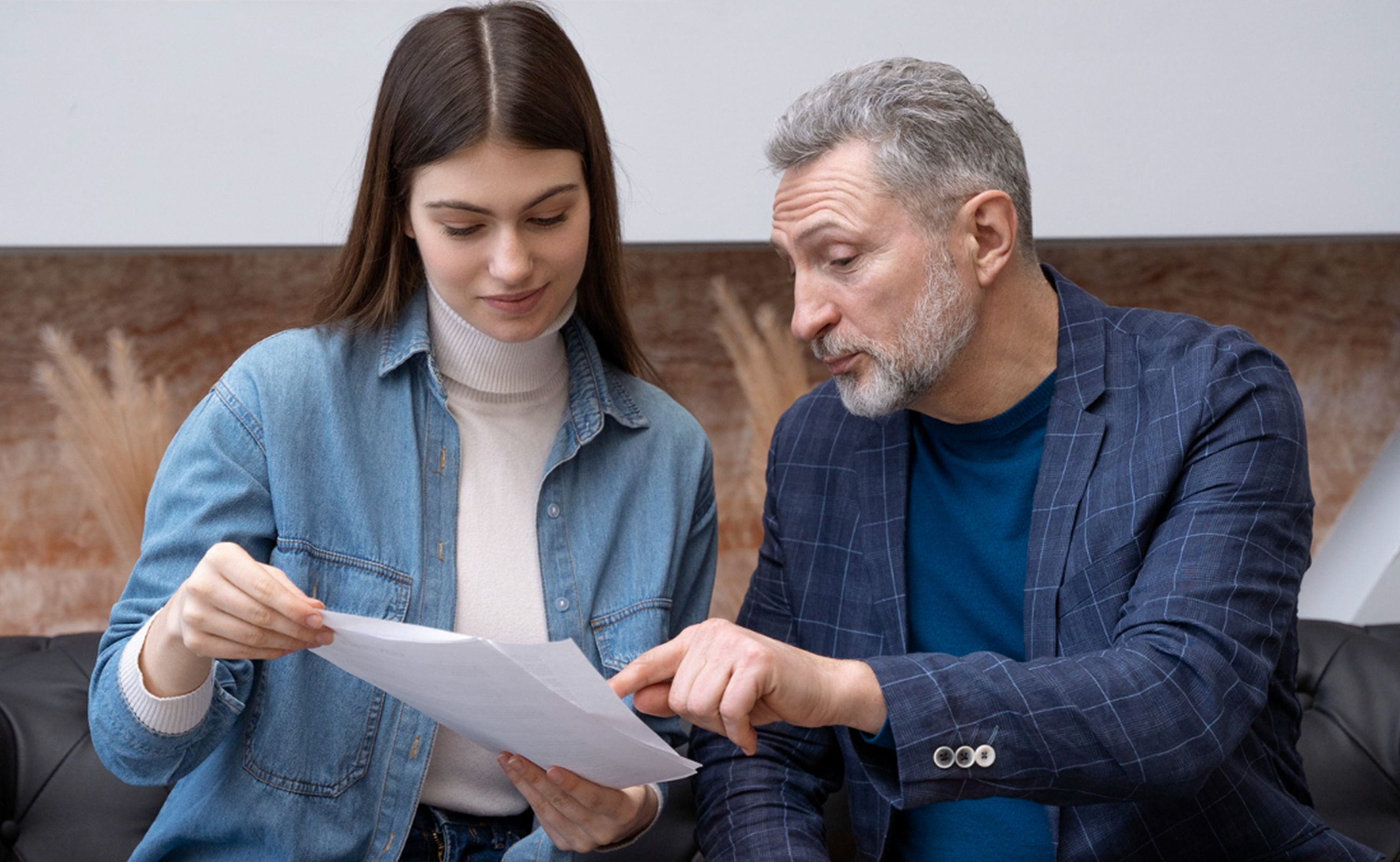 Two colleagues reviewing a printed report together